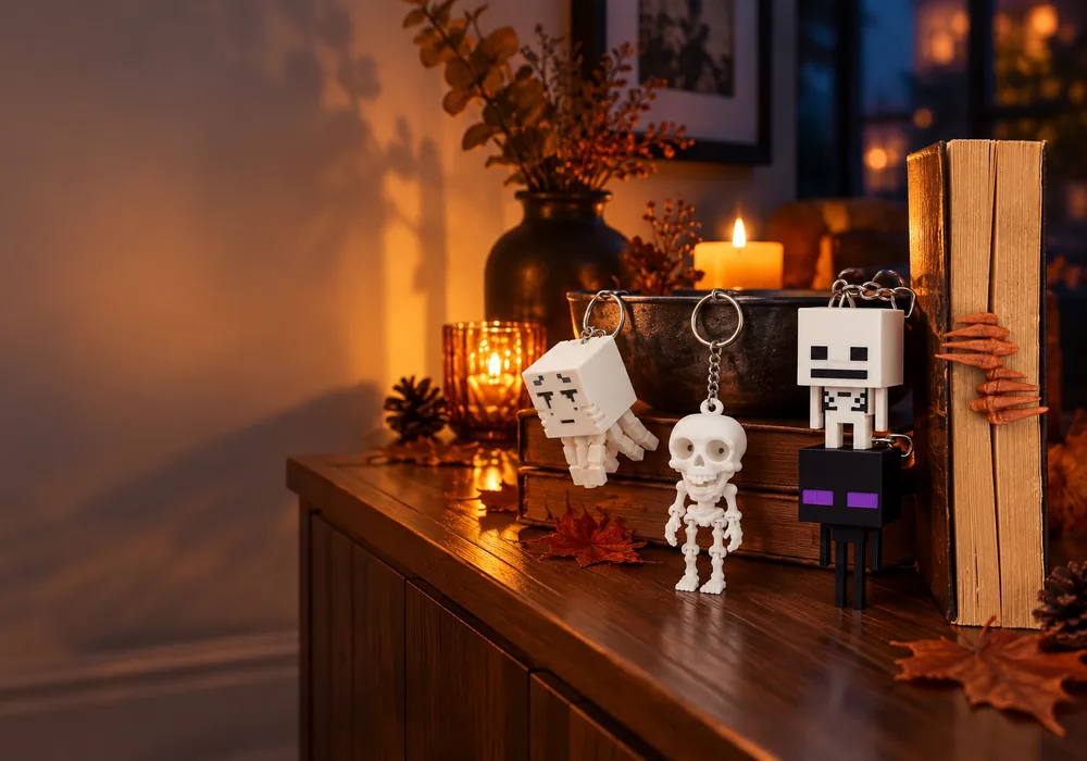 Evening‑lit living room console with pixel ghost, moving skeleton, and pixel character keychains, plus a skeleton‑hand bookmark